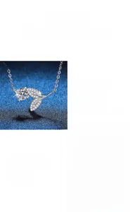 Macro detail of 1ct moissanite necklace with leaf design and 925 silver four-prong setting