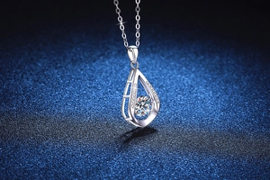 Close-up of S925 silver water drop pendant with dancing moissanite center stone