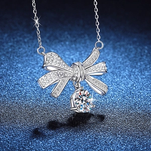 Elegant S925 sterling silver bow pendant necklace with 2ct Moissanite on dark background