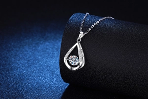 Macro shot of 925 sterling silver water drop necklace with 1ct dancing moissanite stone