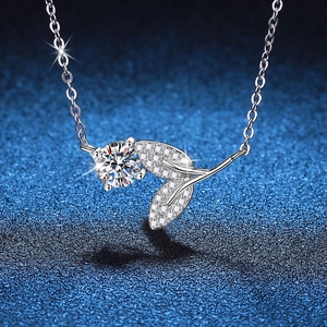 925 silver moissanite necklace with leaf pendant and sparkling main diamond on blue background