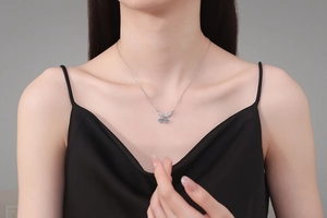 Detail of 925 sterling silver butterfly pendant with 1 carat moissanite on female model