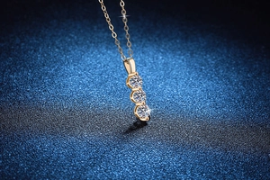 Macro shot of 18K gold-plated S925 silver necklace with three vertical moissanite stones