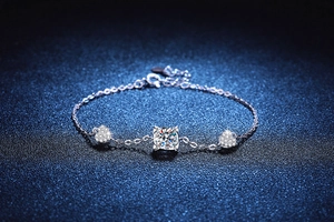 Detail of S925 sterling silver bracelet with moissanite center and heart accents