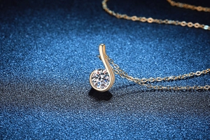 Macro shot of 925 sterling silver music note pendant necklace with sparkling gemstone