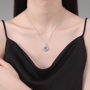 Elegant S925 sterling silver necklace with a 1ct dancing moissanite pendant on a model