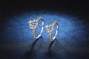 Detail of 925 sterling silver angel wing rings featuring six-prong moissanite settings