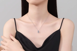 Close-up of a 925 sterling silver water-drop moissanite pendant on a delicate chain