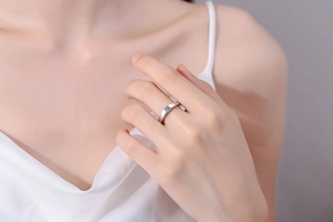 Close-up of S925 sterling silver ring with a round moissanite stone on model hand