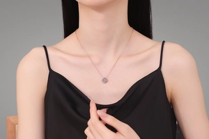 Rose gold clover necklace with 1.2ct blue moissanite crystals worn by a model