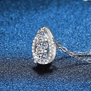 Elegant 925 sterling silver necklace with sparkling waterdrop moissanite pendant on blue background