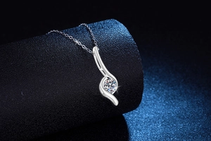 Detailed view of S925 silver necklace with round Moissanite pendant on a black display