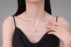 Close-up of S925 sterling silver moissanite pendant necklace worn by a model