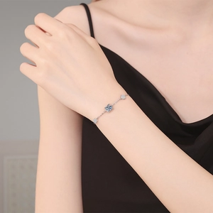 Elegant S925 sterling silver chain bracelet with square blue gemstone on a woman's wrist