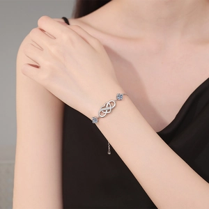 Elegant S925 sterling silver bracelet featuring infinity double hearts and blue moissanite