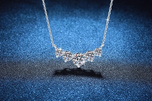 Macro shot of silver S925 sterling silver necklace with five sparkling moissanite stones