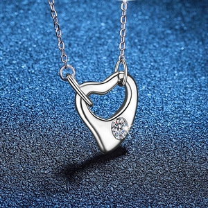Asymmetric hollow heart S925 silver necklace with sparkling moissanite on blue background