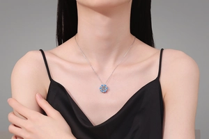 Detail of S925 silver snowflake necklace with dancing moissanite on a model