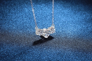 Detailed close-up of three brilliant-cut Moissanite stones on a S925 silver necklace