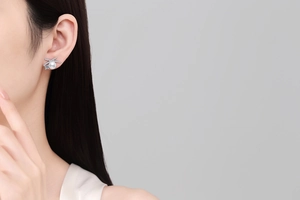 Close-up of S925 silver butterfly X-shaped earring with freshwater pearl and moissanite
