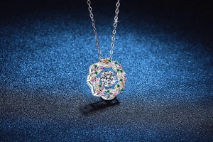 Close-up of S925 sterling silver starburst pendant with colorful gemstone halo