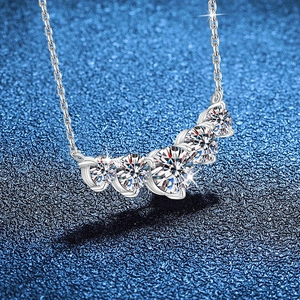 S925 sterling silver necklace with five graduated round moissanite stones in a smile arc