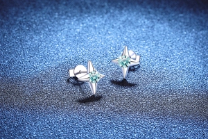 Detail of S925 silver star earrings with round cut blue moissanite and classic pin structure