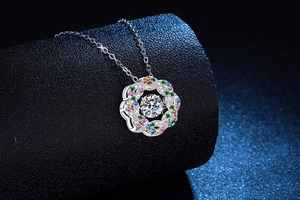 Macro detail of 925 sterling silver starburst pendant with colorful pavé moissanite stones