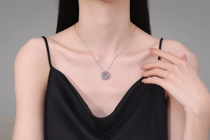 Detail of S925 silver necklace with 1ct moissanite and colorful halo on female neck