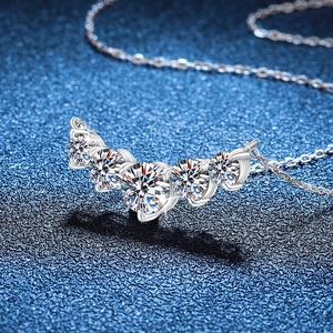 S925 sterling silver necklace with five graduated D-color moissanite stones on a blue background
