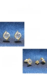 Close-up of polished 1 carat moissanite earrings with 14k gold plated swirl design
