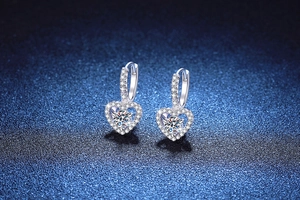 Macro detail of S925 sterling silver heart earrings featuring 1ct moissanite and pave setting