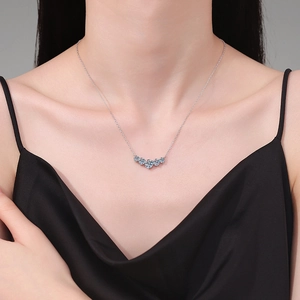 Elegant S925 silver necklace featuring five blue moissanite stones in a smile curved design