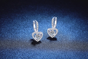 Macro shot of S925 silver heart drop earrings with 1ct moissanite and micro-pave stones