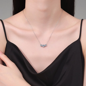 S925 sterling silver necklace with three blue moissanite stones on a female model
