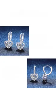 Detailed macro view of heart-shaped moissanite earrings with silver pavé setting