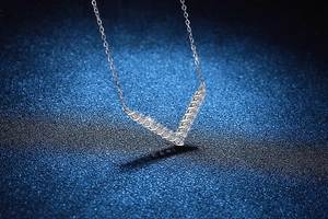 Vue macro du collier avec pendentif en V en argent s925 serti de pierres moissanite