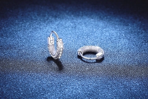 Macro shot of S925 sterling silver hoop earrings with pavé-set round moissanite stones