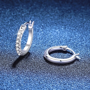Elegant S925 sterling silver hoop earrings featuring pavé-set moissanite on blue background