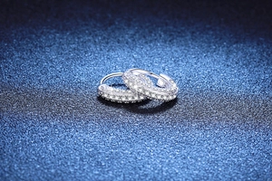 Detailed macro view of S925 sterling silver huggie earrings with pave-set moissanite