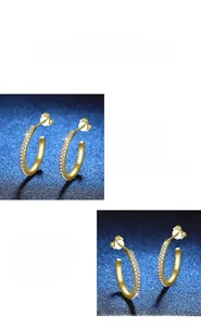 Close-up of golden S925 silver J-shaped earrings with micro-pave moissanite stones