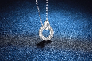 Macro detail of 925 sterling silver necklace with sparkling moissanite halo pendant