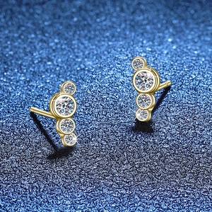 Elegante goldene gebogene Moissanit-Ohrstecker mit runden Clustern auf dunkelblauem Hintergrund