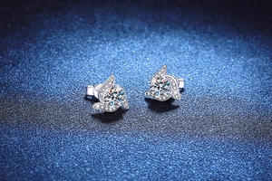 Close-up of 925 sterling silver moissanite stud earrings with rotating swirl design