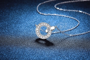 Macro shot of 925 sterling silver ring pendant with sparkling moissanite on blue background