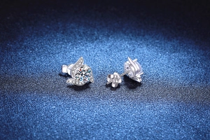 Macro shot of 925 sterling silver windmill stud earrings with round moissanite center