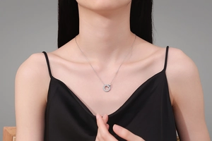 Close-up of S925 sterling silver necklace with sparkling Moissanite pendant on a model