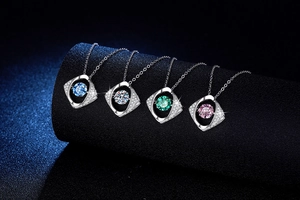 Detail of four S925 silver necklaces with blue, white, green, and pink dancing stones