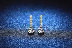 Detail of 2ct moissanite drop earrings in gold finish with micro-pave diamond bar