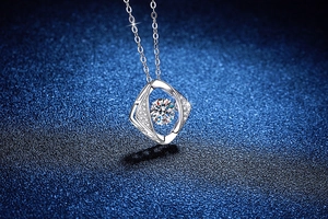 Close-up of sparkling geometric moissanite heart pendant with silver chain detail